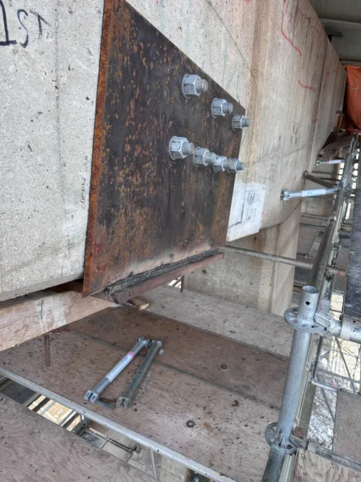 Steel plates and anchors installed against concrete