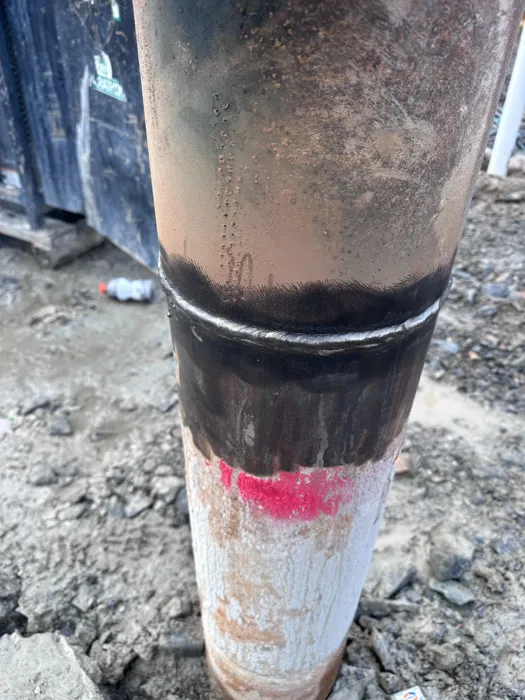 Close-up of a circumferential weld on a steel pipe