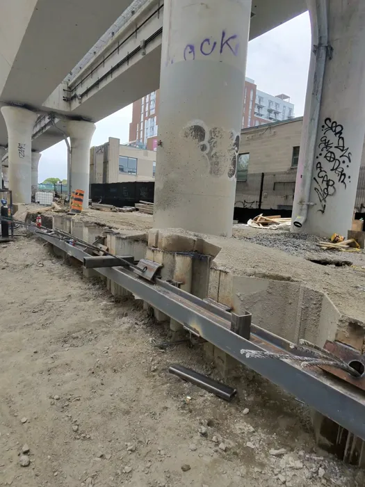 Steel beam installation beside concrete columns